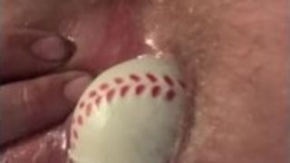 Sticking foam baseball in ass/close up